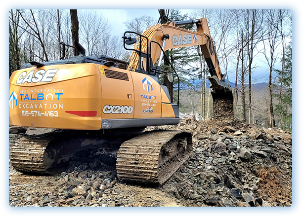 Excavation en Estrie – Pelle mécanique CASE des Entreprises Talbot en action sur un terrain rocheux à Sherbrooke pour des travaux de construction neuve.